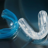 Closeup of mouthguards to protect dental implants in Asheville