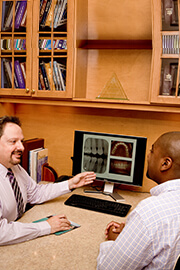 Dr. White consulting with a patient 