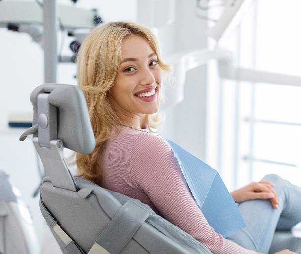 Woman smiling while sitting in treatment chair