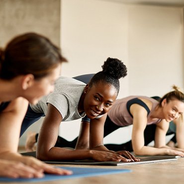 Group of women smiling during workout class