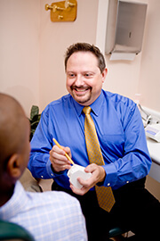 Doctor White instructing patient about dental bridges