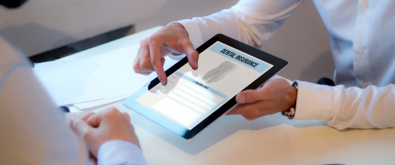 Showing patient form for dental insurance on tablet