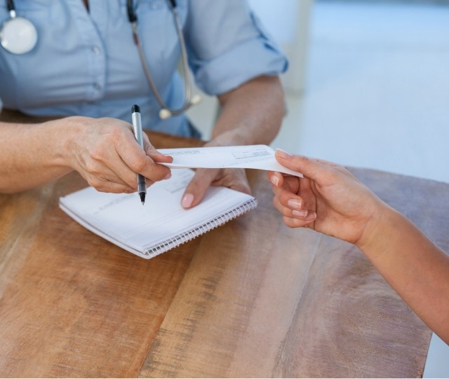 Dentist handing dental patient a note