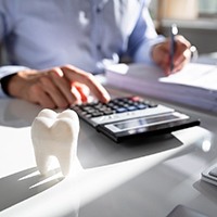 Dentist calculating the price of dental implants in Asheville 