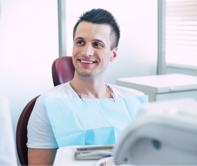 Male dental patient in white shirt smiling
