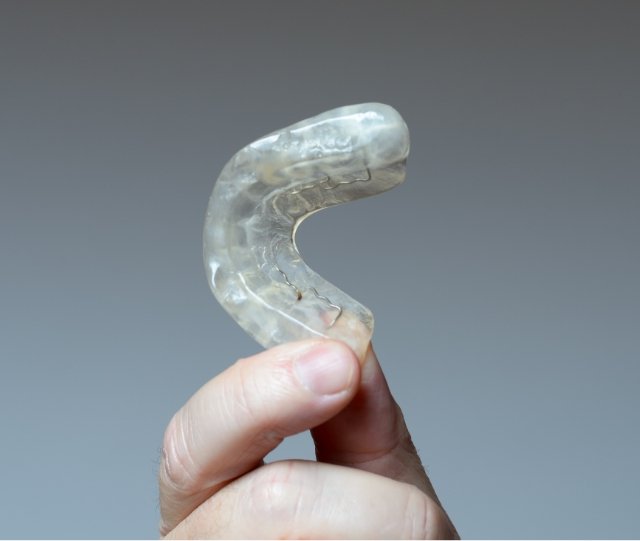 Hand holding a nightguard for bruxism
