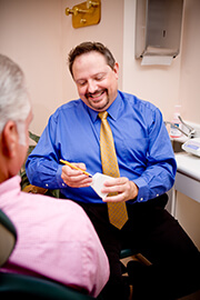 Doctor White consulting dentures with patient 