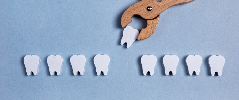 Forceps removing tooth from row of teeth