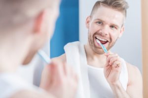 man brushing teeth