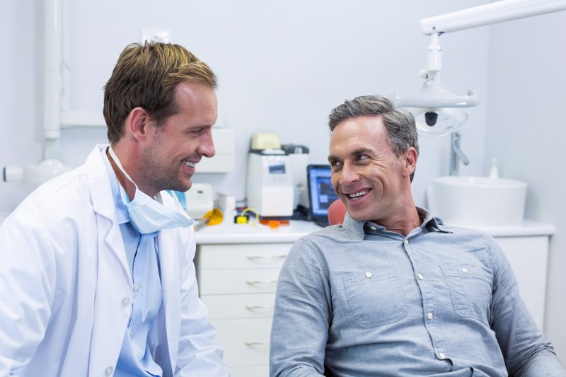 person whose dental bridge fell out talking to dentist