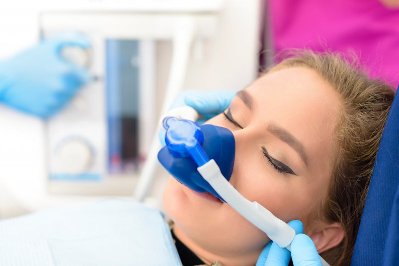 A woman receiving sedation dentistry during treatment