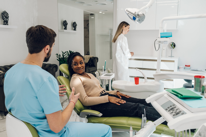 Patient talking to dentist about oral cancer screenings