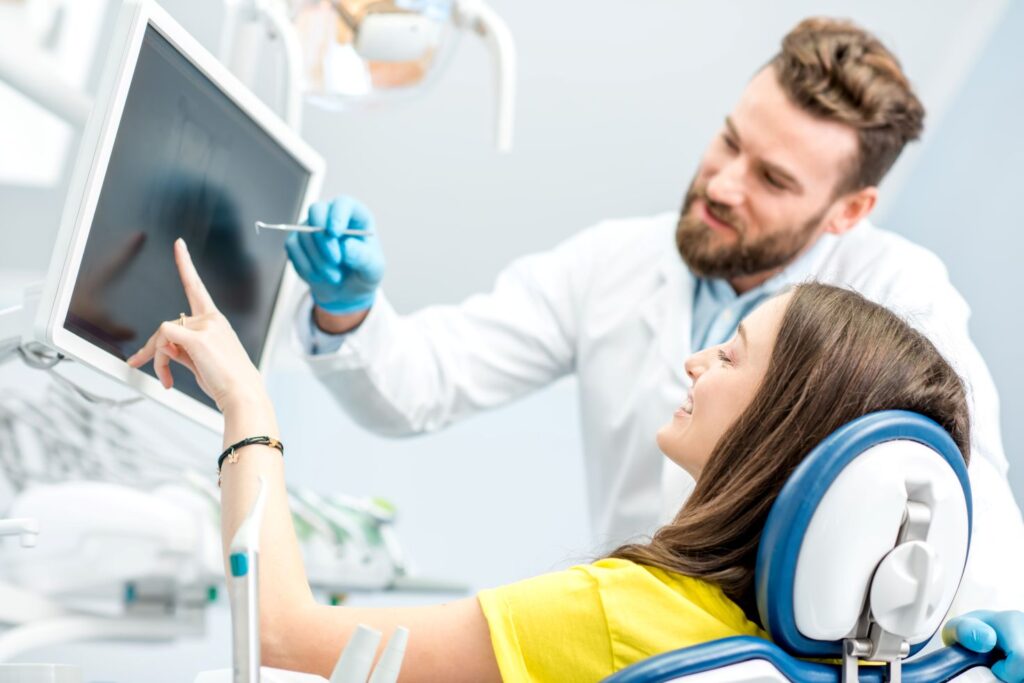 A female patient discussing her oral health with a dentist